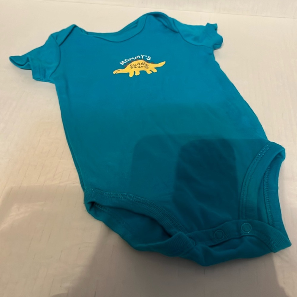Size 6 months teal colored onesie W/ mommy’s cuddle saurus. Gently worn